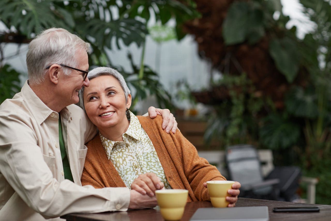 Happy senior couple enjoying coffee together at home - Godaelli Home Care